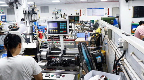Production equipment and operators in a CNL eyewear workshop